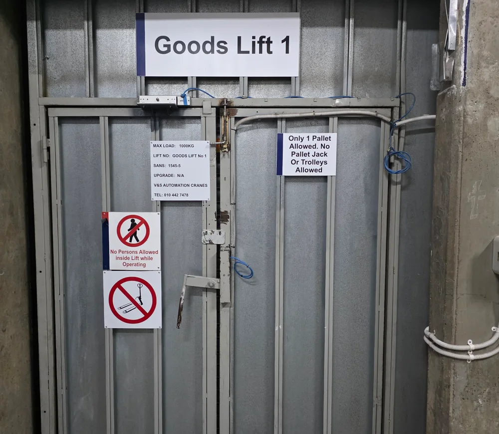 Closed landing doors beneath a Goods Lift 1 sign