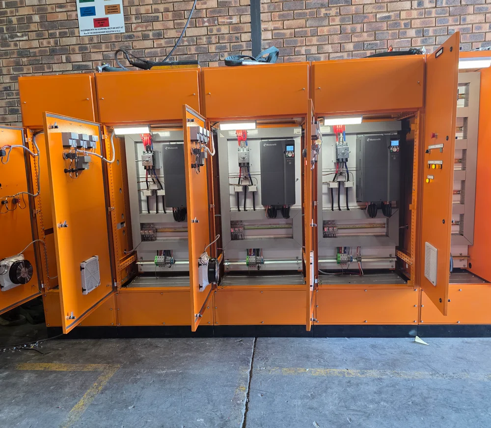 Orange multi-section control cabinet with internal components exposed